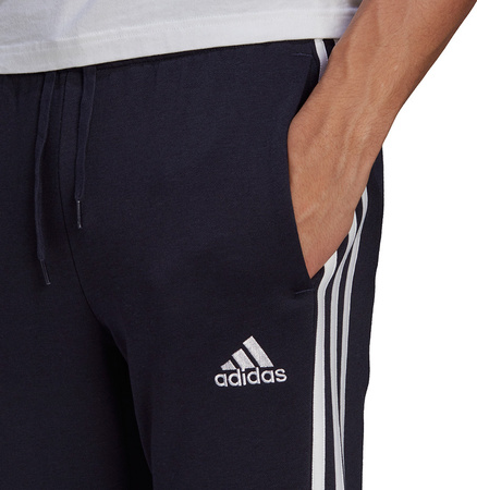 Spodnie męskie adidas Essentials Fleece Tapered Cuff 3-Band Pants granatowe GK8823