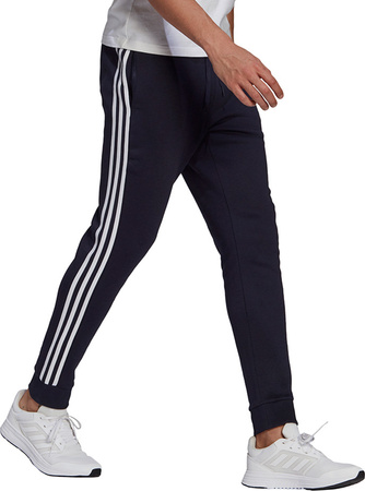 Spodnie męskie adidas Essentials Fleece Tapered Cuff 3-Band Pants granatowe GK8823